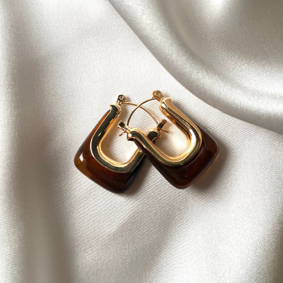 Tortoise shell inspired resin detail in a gold tone finish. These earrings are the perfect balance for everyday looks to night out. 