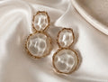 Lumina Drops gold statement earrings featuring luminous textured ivory stones on ivory satin fabric.  
Perfect for weddings, special occasions, vacations and elevated everyday wear
